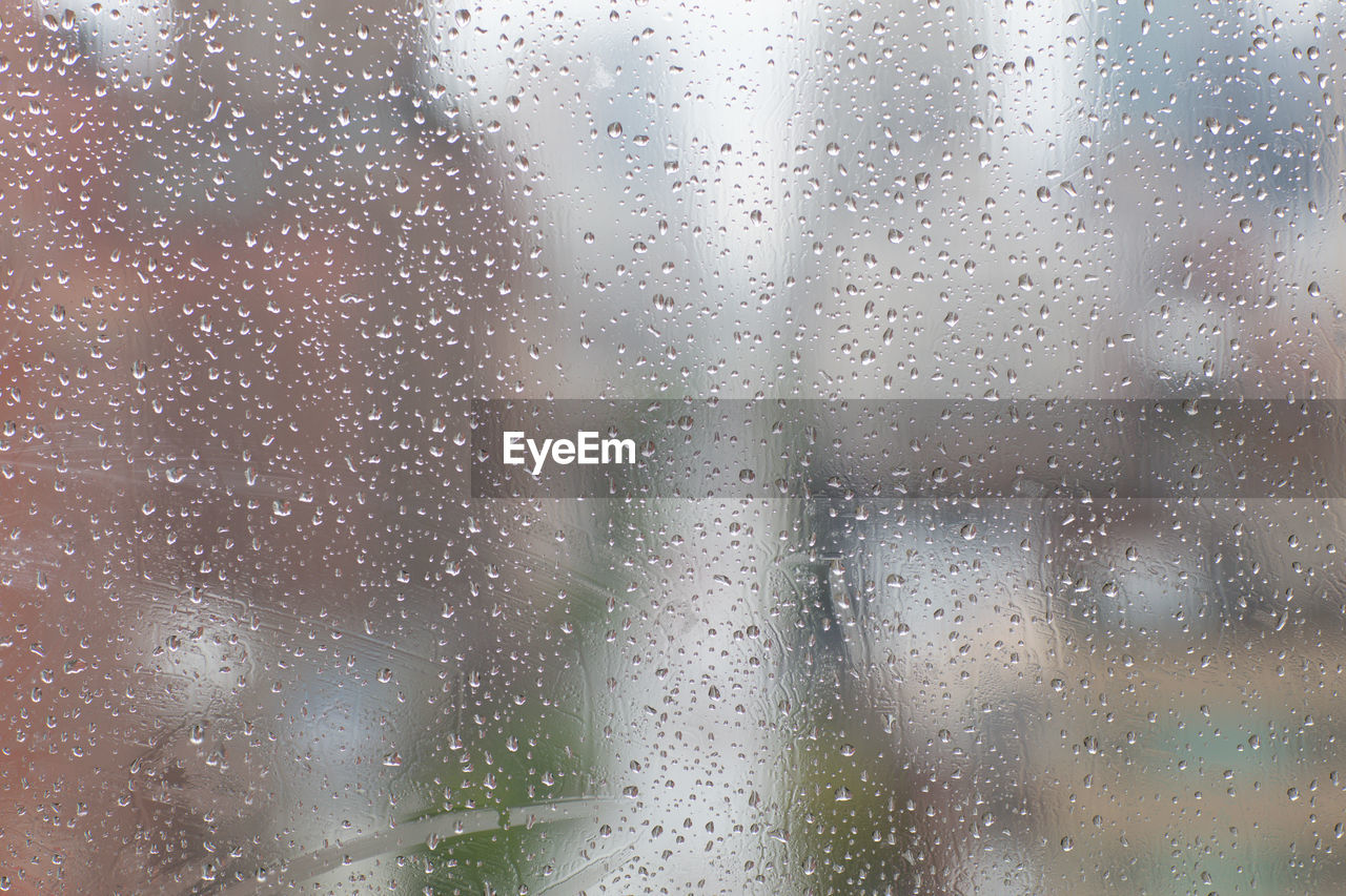 Full frame shot of raindrops on glass window