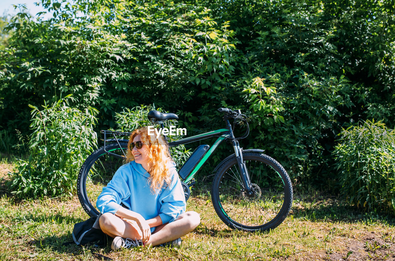 A young woman uses a modern electric bicycle for sports and outdoor recreation