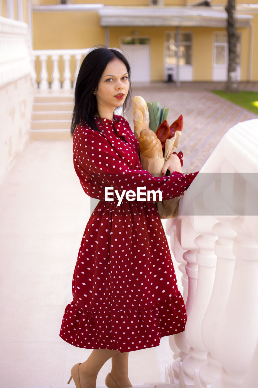 women, one person, adult, pink, clothing, fashion, smiling, happiness, dress, pattern, young adult, female, emotion, architecture, portrait, cheerful, polka dot, red, photo shoot, lifestyles, elegance, cute, standing, full length, hairstyle, positive emotion, animal, looking at camera, child, person, brown hair, long hair, holding, animal themes, looking, mammal, nature, indoors