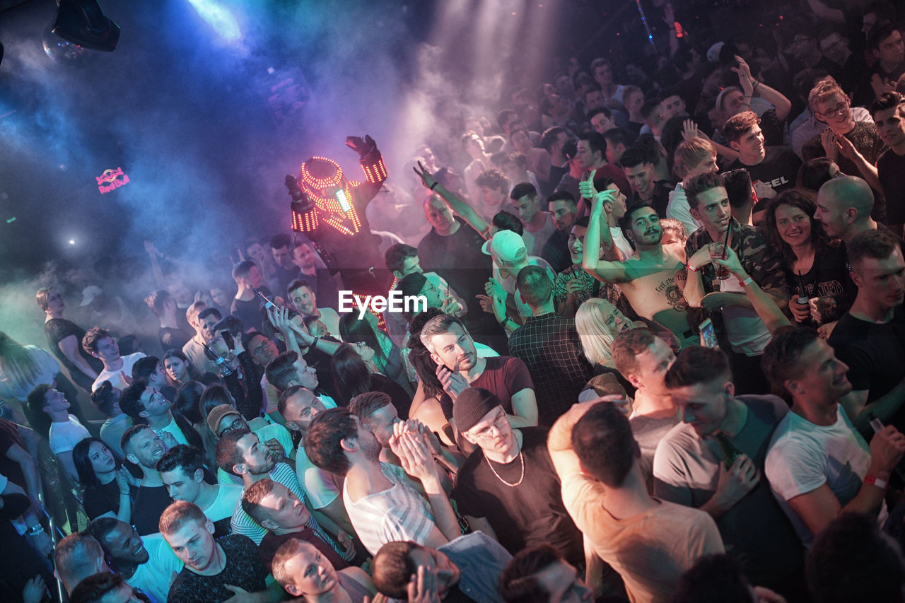 HIGH ANGLE VIEW OF PEOPLE AT MUSIC CONCERT