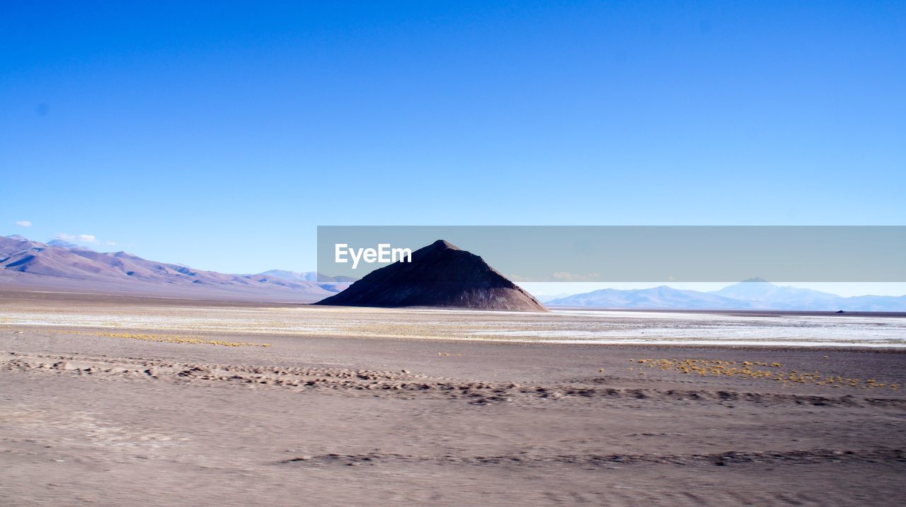 SCENIC VIEW OF DESERT AGAINST BLUE SKY