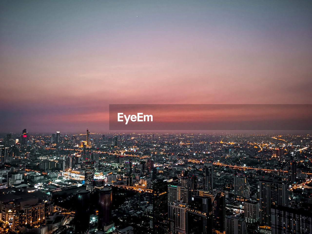 High angle view of illuminated buildings against sky during sunset