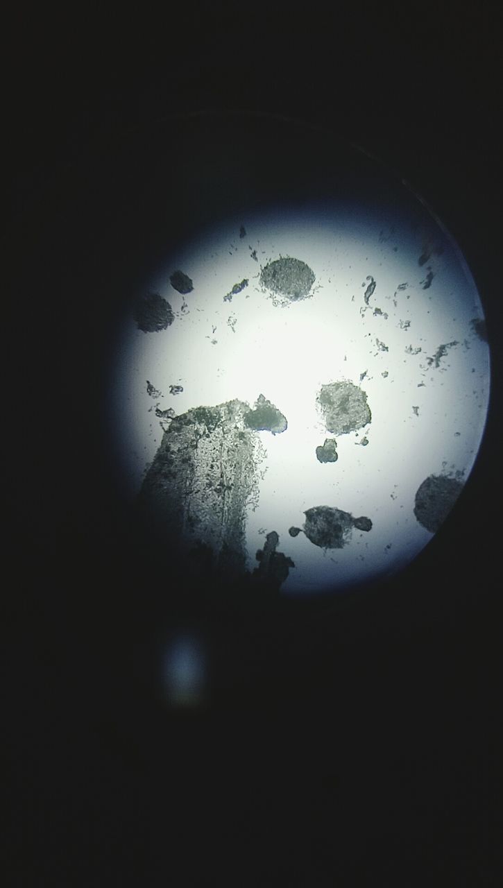 CLOSE-UP OF WET GLASS WINDOW IN DARK