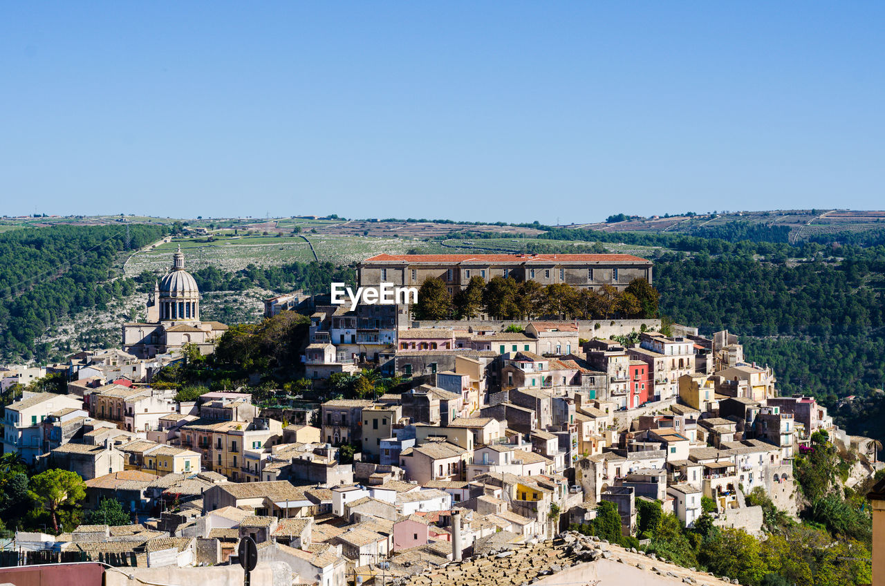 VIEW OF TOWNSCAPE AGAINST CLEAR BLUE SKY