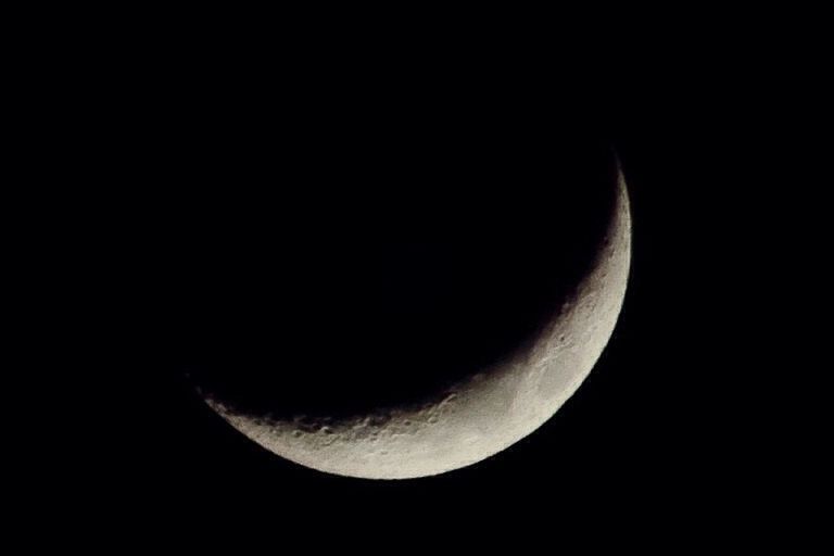 CLOSE-UP OF MOON OVER BLACK BACKGROUND