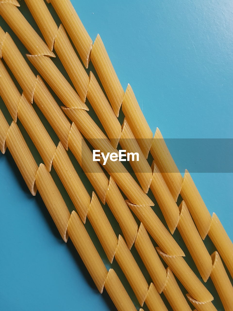 High angle view of pasta against blue background 