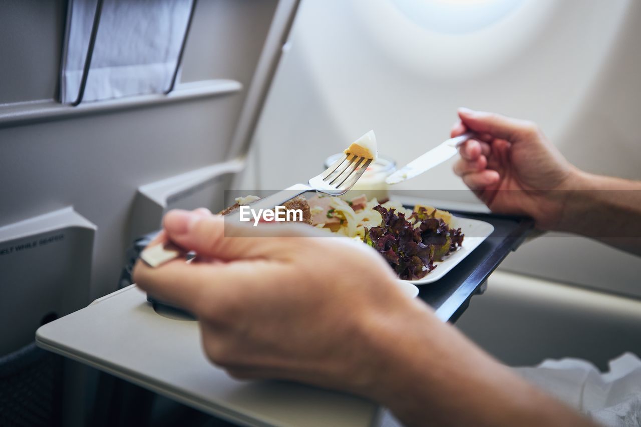 Cropped image of woman holding food