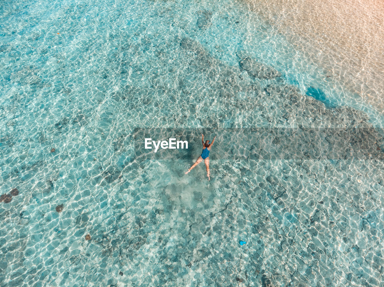 Aerial view of woman swimming in sea