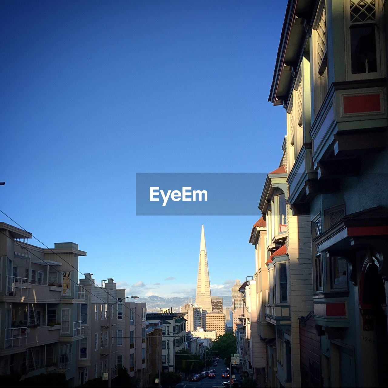 BUILDINGS IN CITY AGAINST CLEAR BLUE SKY