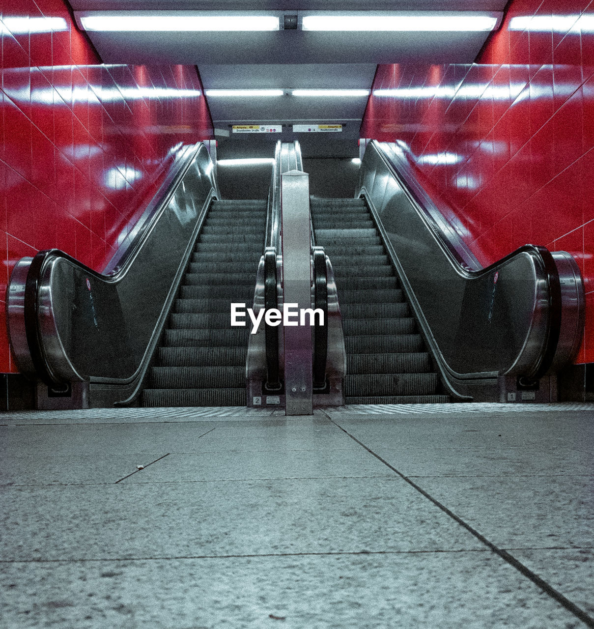 REAR VIEW OF PEOPLE ON ESCALATOR IN SUBWAY