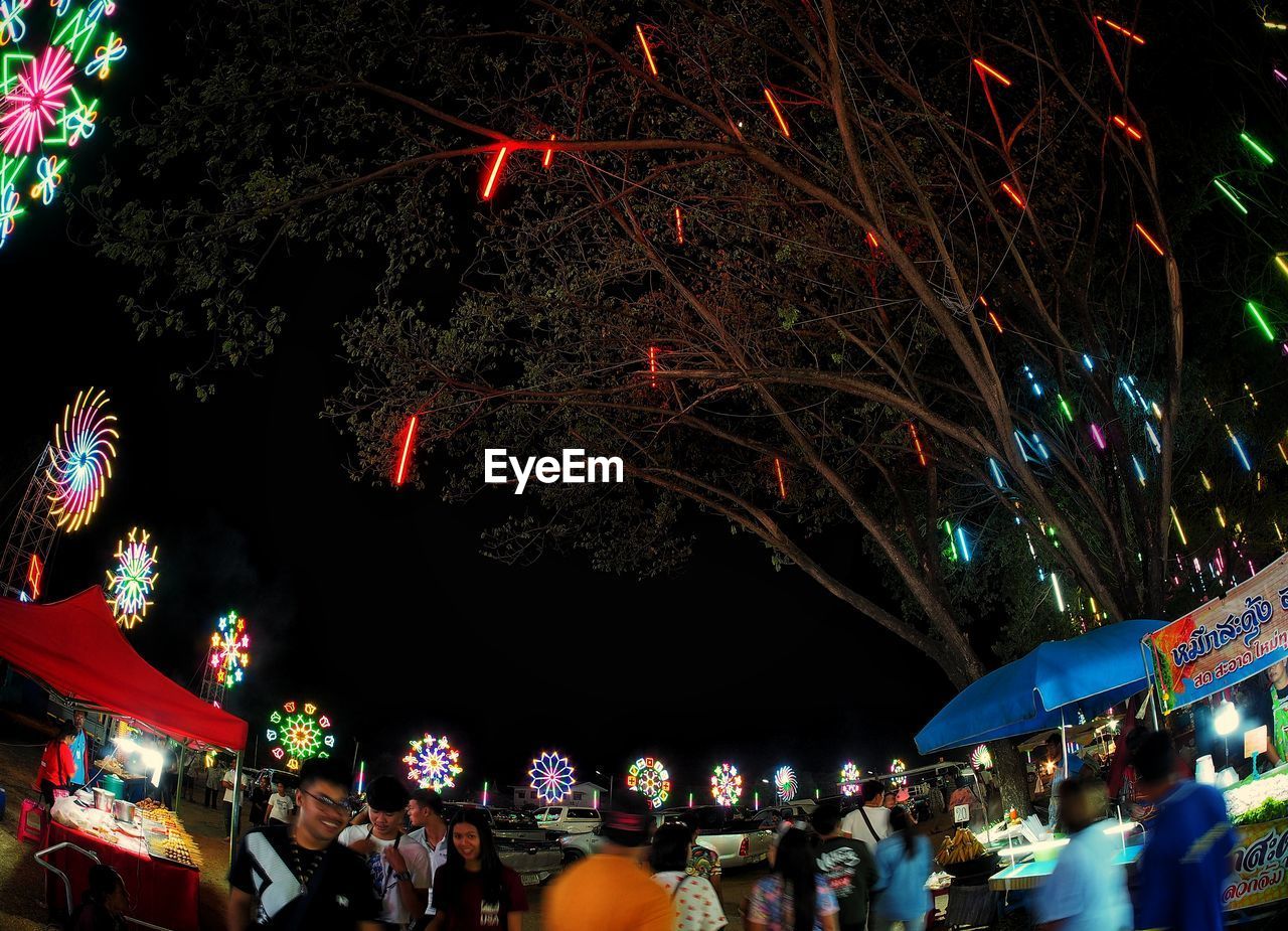 PEOPLE AT ILLUMINATED MARKET