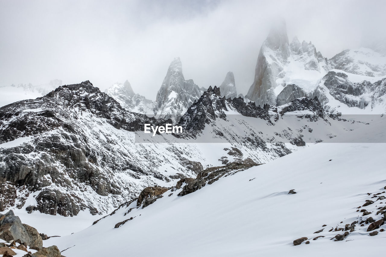 Scenic view of snow covered mountains against sky