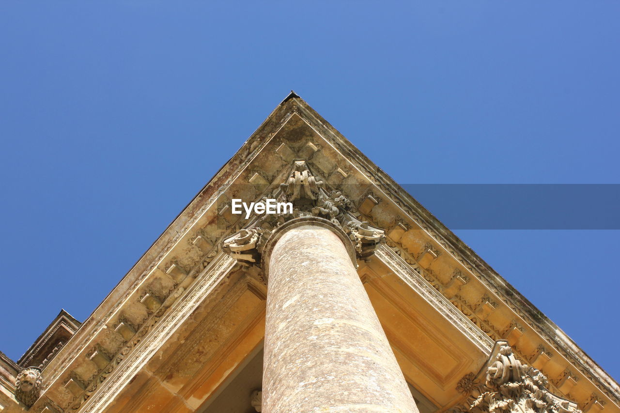 High section of built structure against clear blue sky