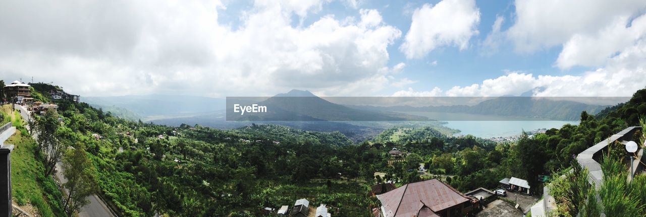 Panoramic view of trees and buildings against sky