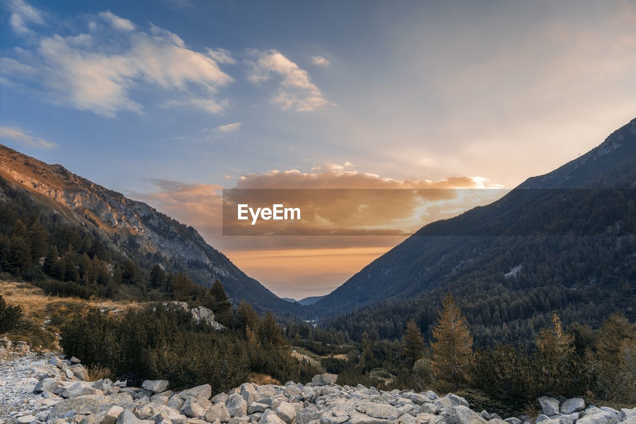 Scenic view of snowcapped mountains against sky during sunset