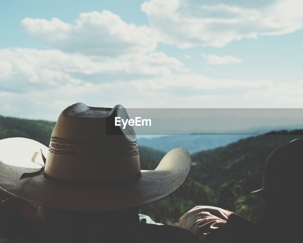 rear view of man wearing hat against sky
