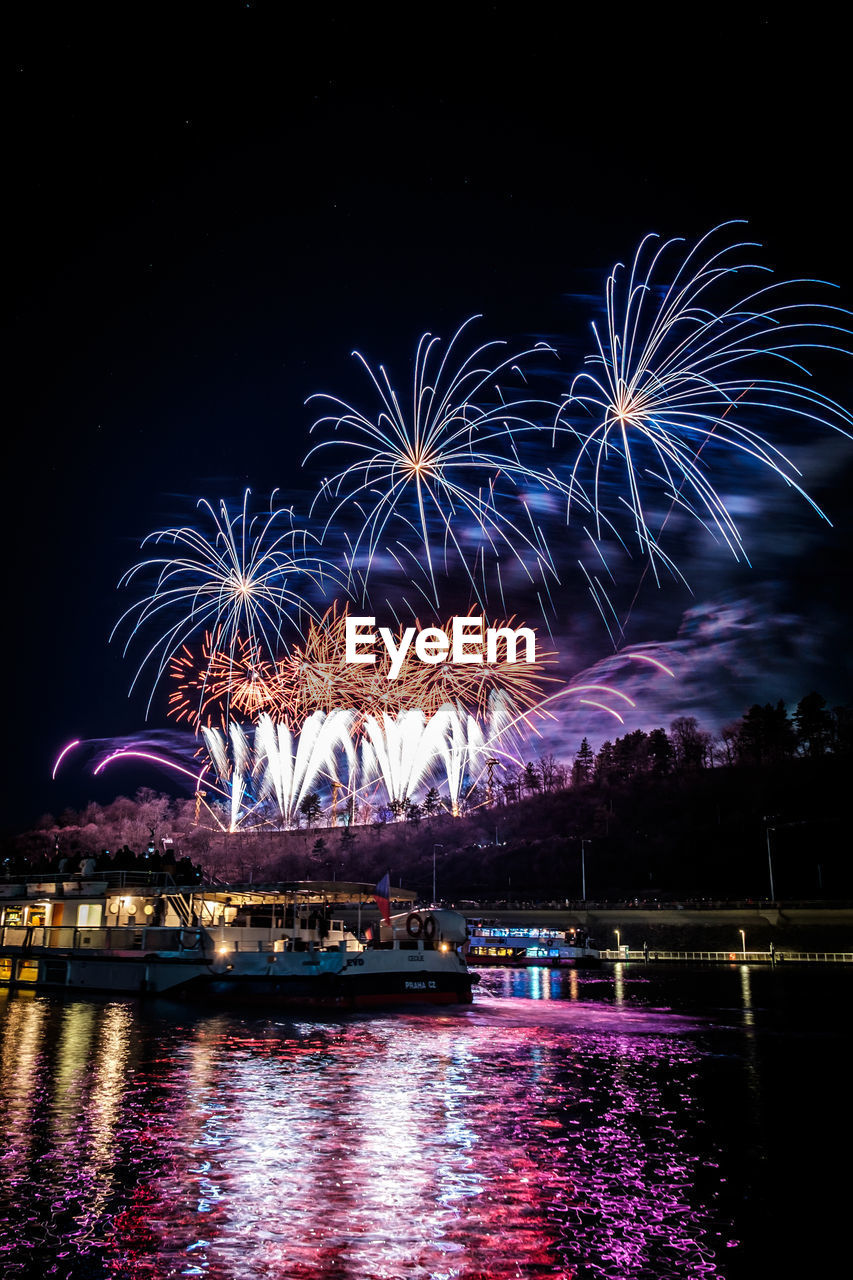 Low angle view of firework display at night