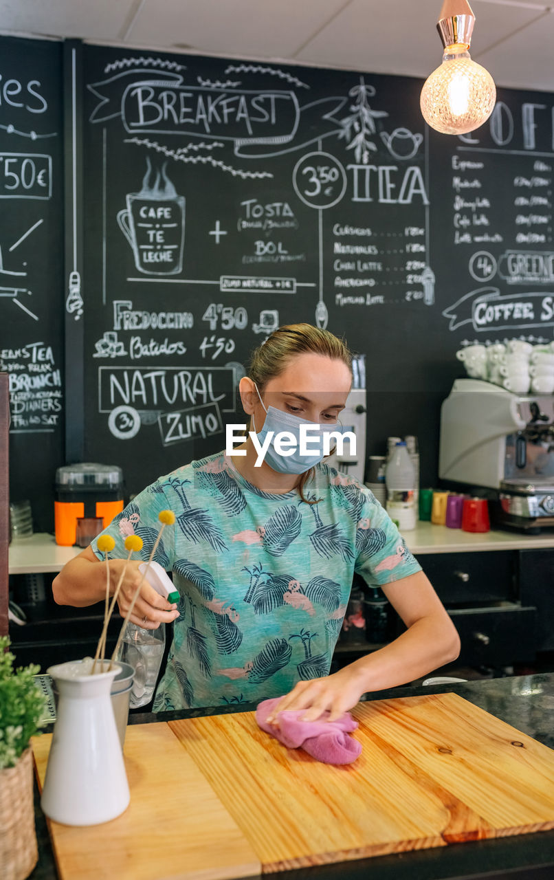 Young man preparing food on table in restaurant