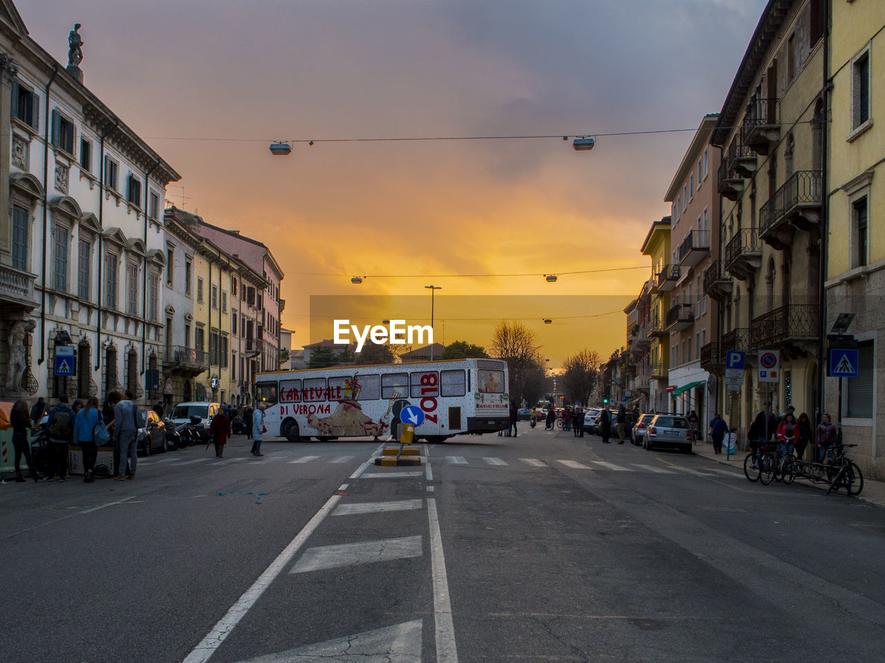 CARS ON STREET IN CITY AGAINST SKY