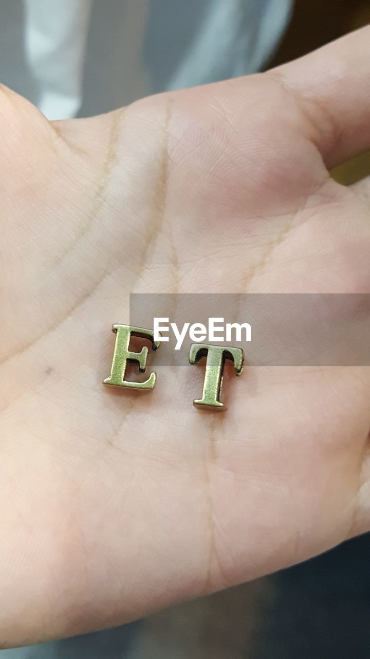 Close-up of letters e and t on palm of hand