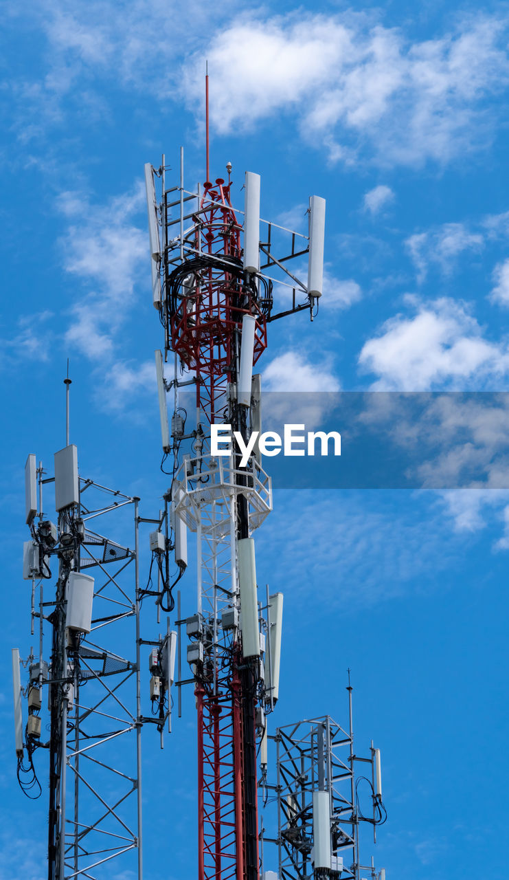 Telecommunication tower with blue sky and white clouds background. antenna on blue sky. 