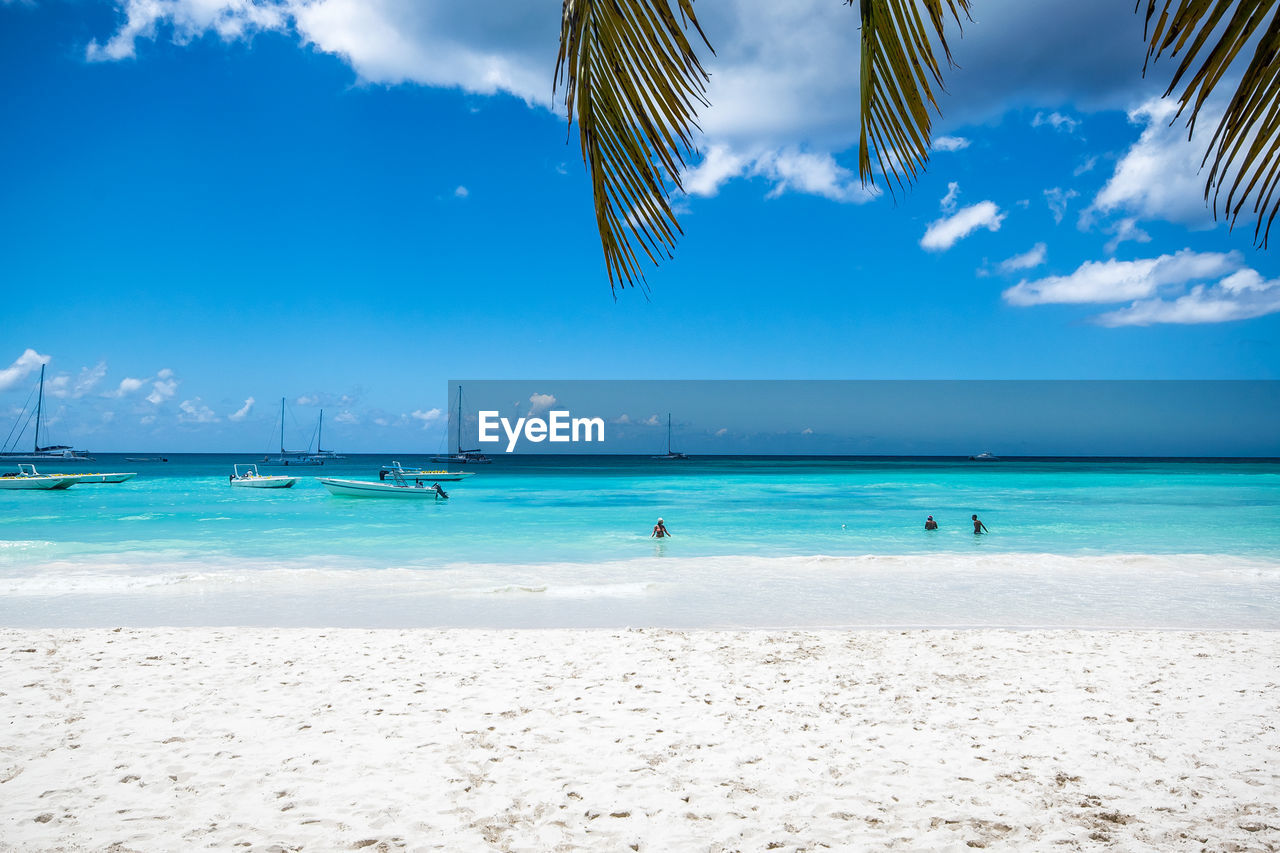 Scenic view of beach against blue sky