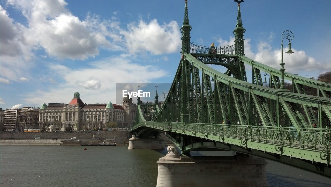 Bridge over river with buildings in distance