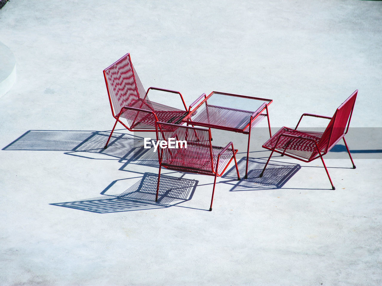 High angle view of red chairs and table on sunny day
