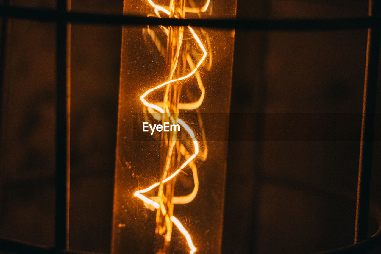 Close-up of illuminated lantern against wall