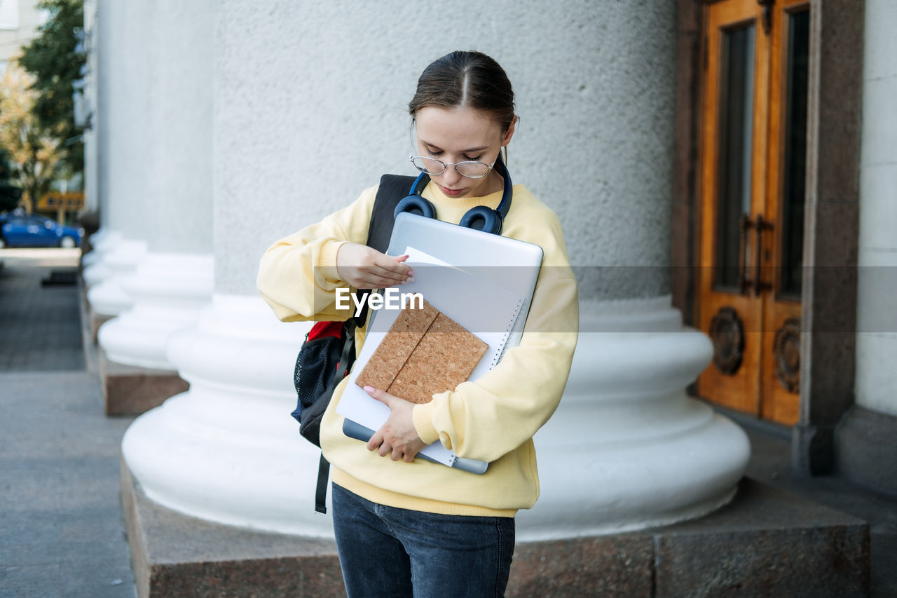 Student loan, student finance for undergraduates. outdoor portrait of student girl