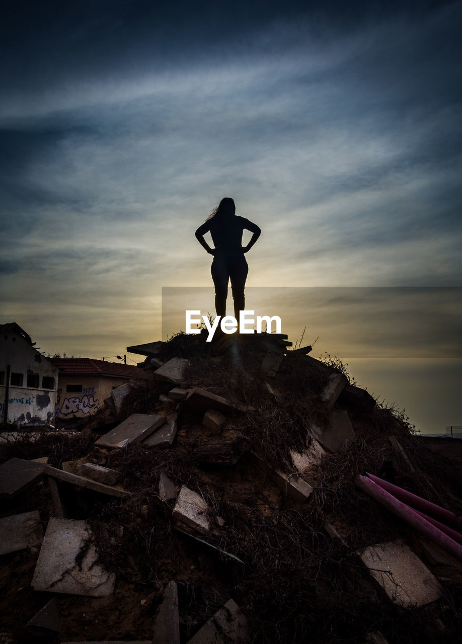 Silhouette of a woman standing against sky