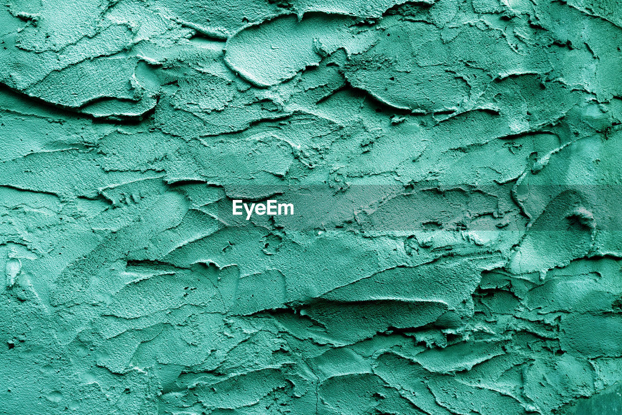 Uneven rough green-turquoise texture. texture of green-turquoise rough wall surface. 