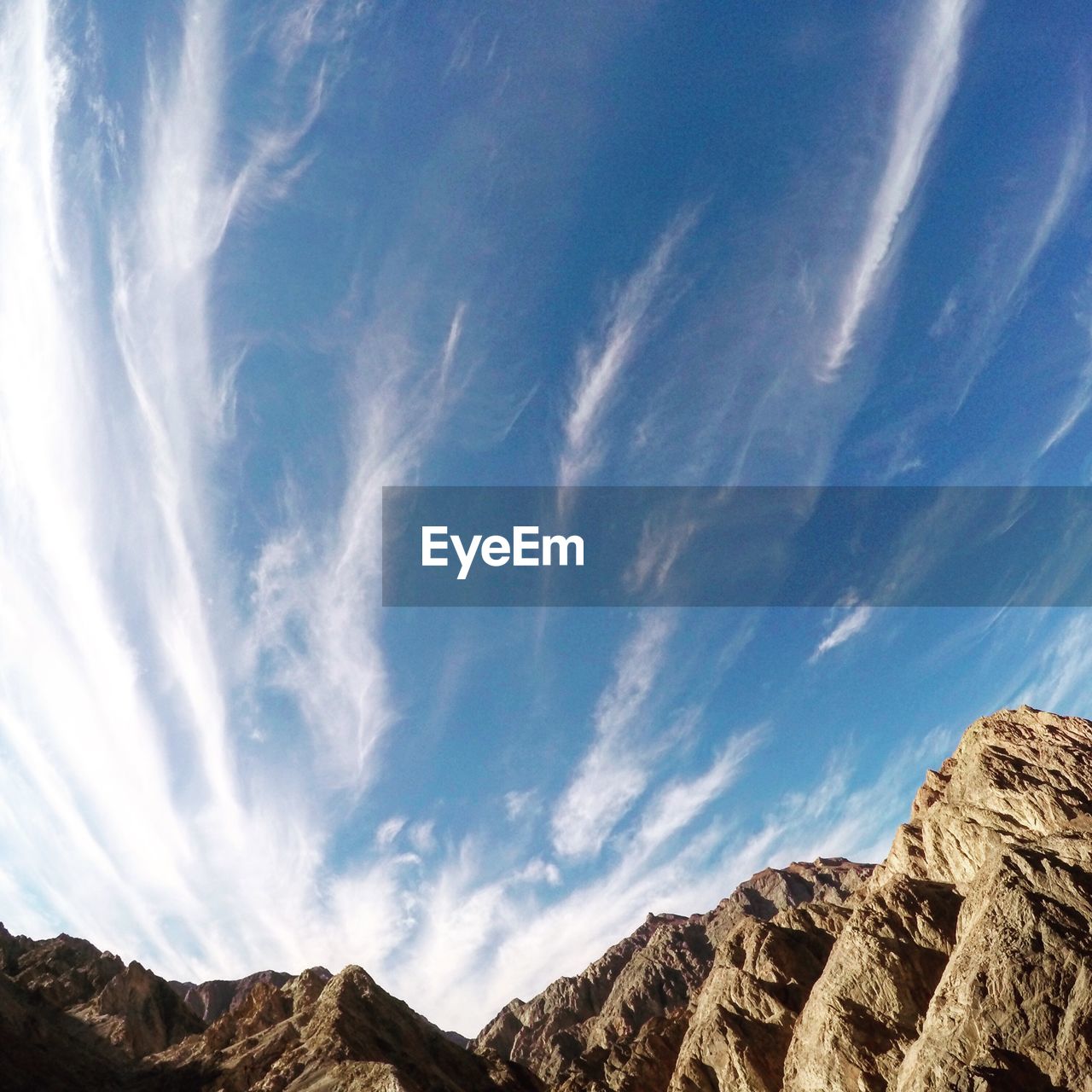 LOW ANGLE VIEW OF MOUNTAIN AGAINST CLOUDY SKY