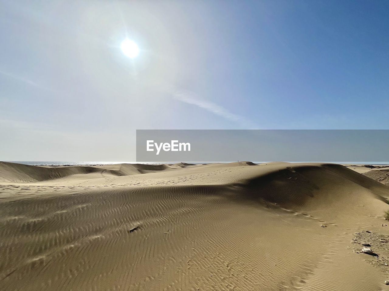 land, sand, sand dune, sky, landscape, scenics - nature, environment, desert, erg, nature, beauty in nature, climate, tranquility, arid climate, sunlight, clear sky, sun, non-urban scene, dune, natural environment, travel, singing sand, sunny, tranquil scene, travel destinations, horizon over land, horizon, animal wildlife, no people, tourism, accidents and disasters, beach, day, footprint, outdoors, cloud, remote, extreme terrain, solitude, absence, natural phenomenon, blue, hill, sea, dry, semi-arid, animal, vacation, summer, trip, water, holiday, sunbeam, physical geography, urban skyline, idyllic, nature reserve