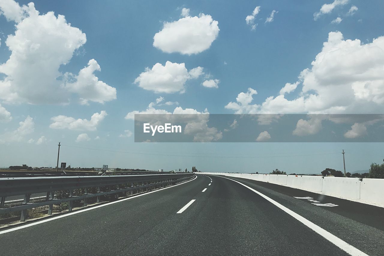 EMPTY ROAD AGAINST CLOUDY SKY