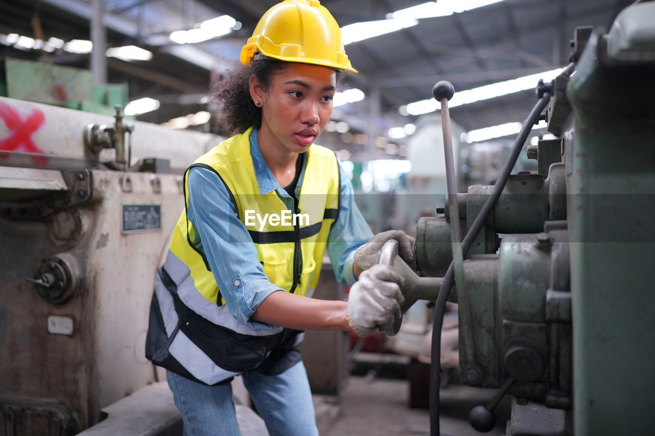 side view of construction worker working at factory