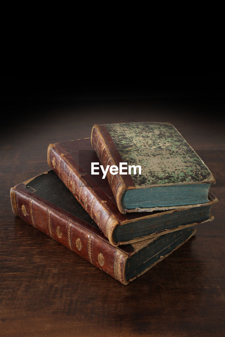 High angle view of books on table against black background