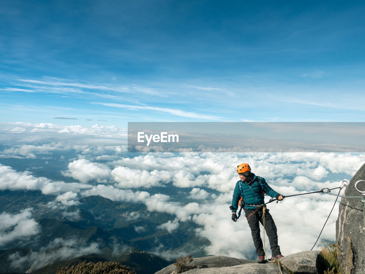 Man hiking on mountain against sky