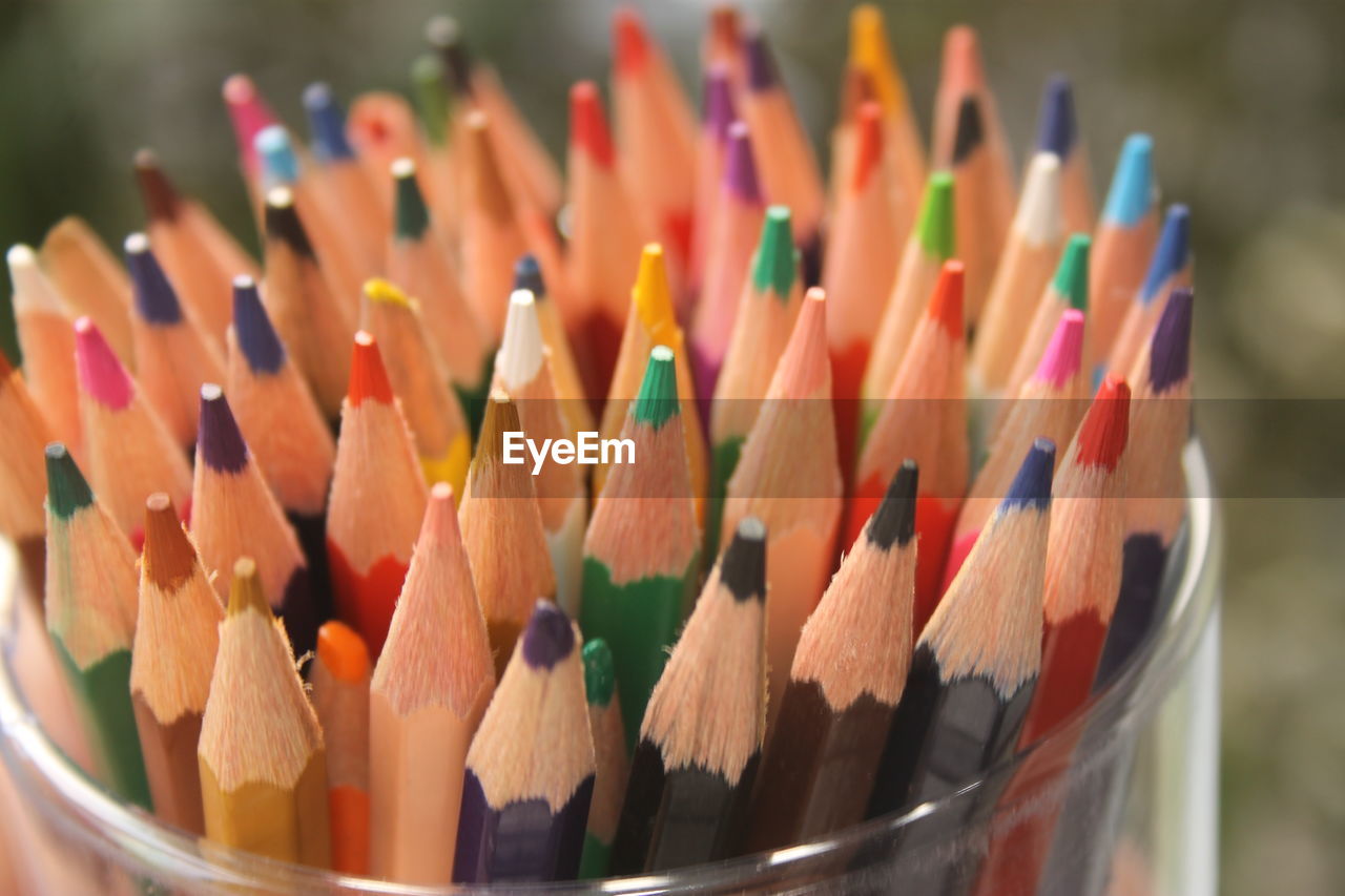 Close-up of multi colored pencils in container