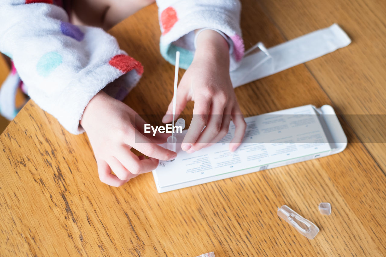 Child testing herself for coronavirus at home.