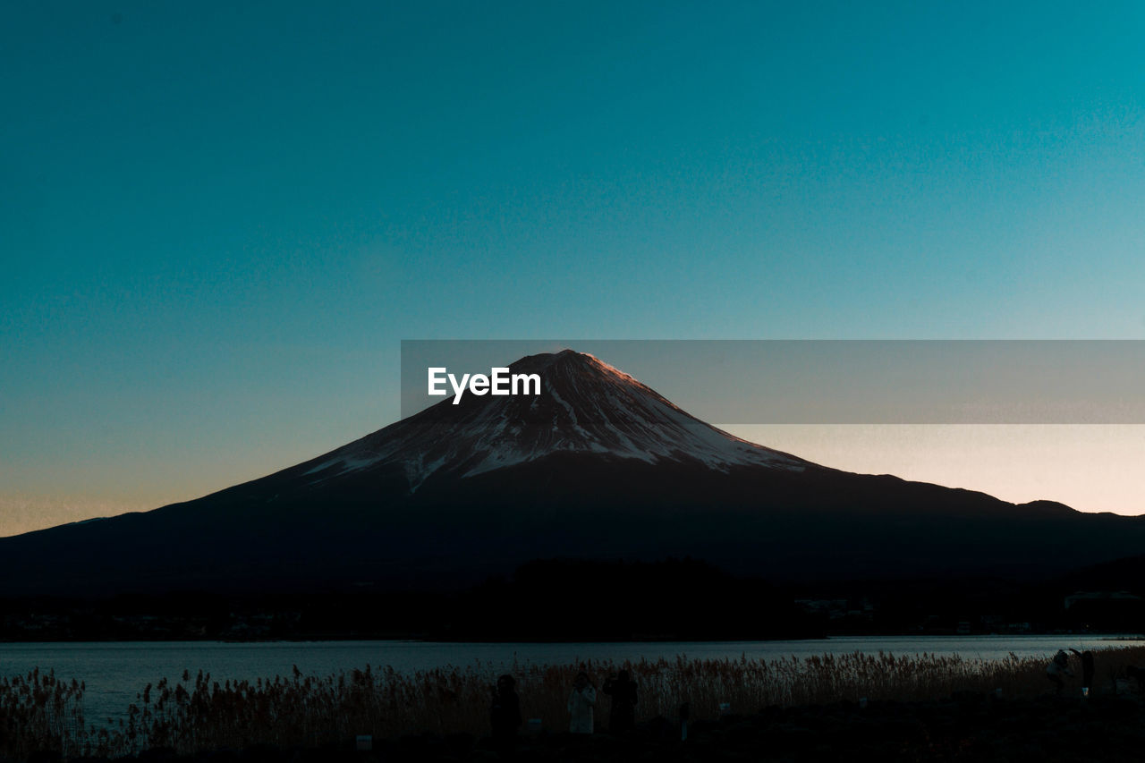 Scenic view of mountains against clear blue sky