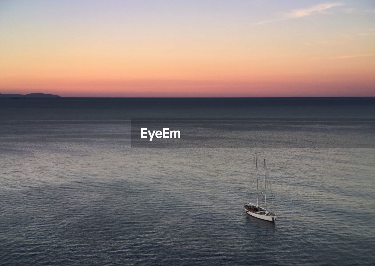 High angle view of sailboat in sea against sky during sunset
