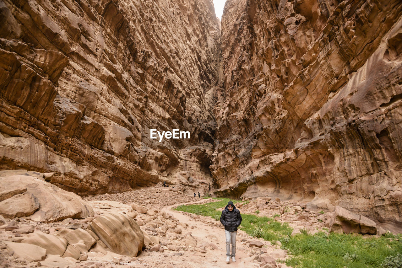 The desert walker. man walking through a canyon in the desert of wadi rum