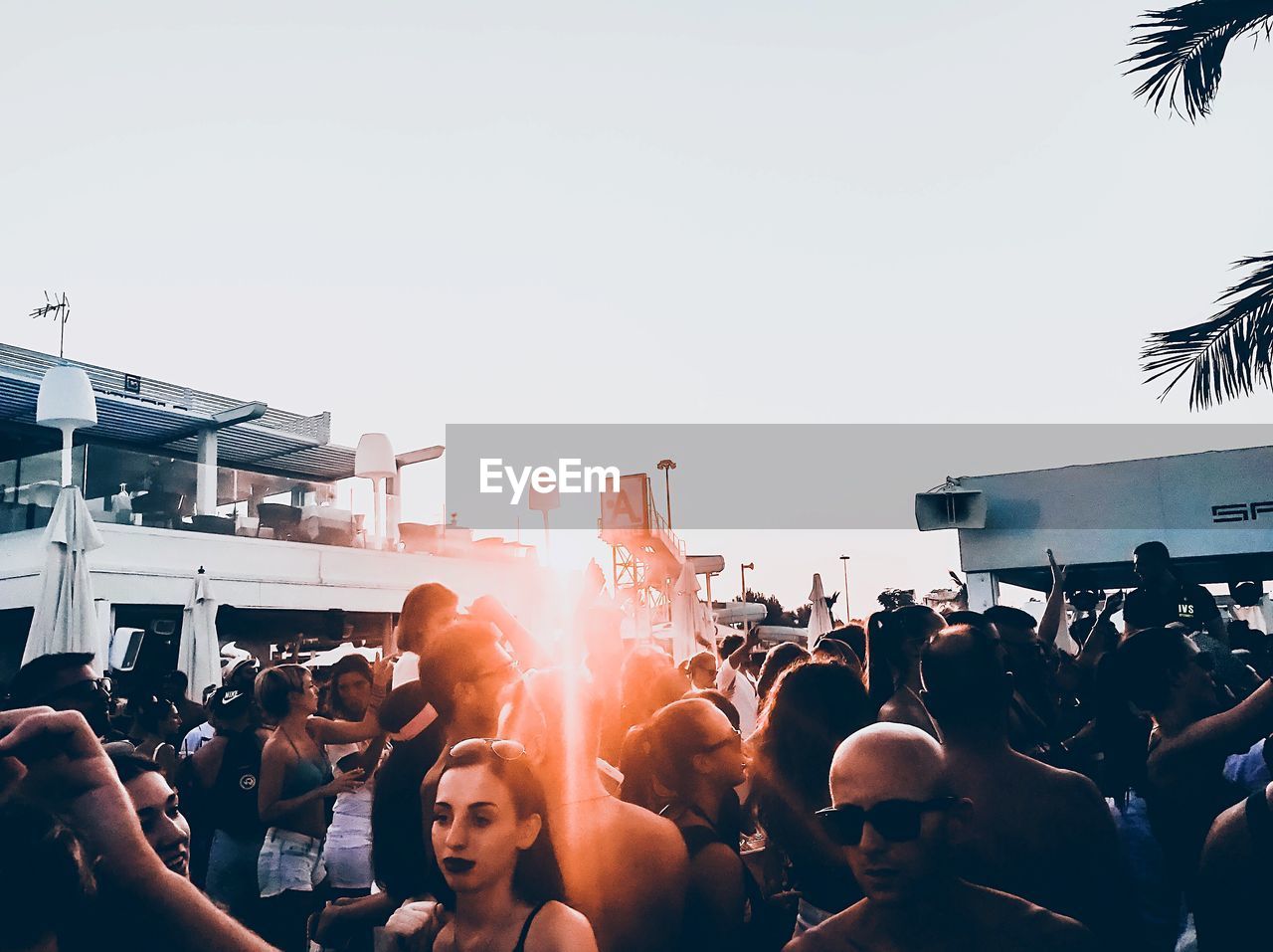 GROUP OF PEOPLE AT MUSIC FESTIVAL AGAINST SKY