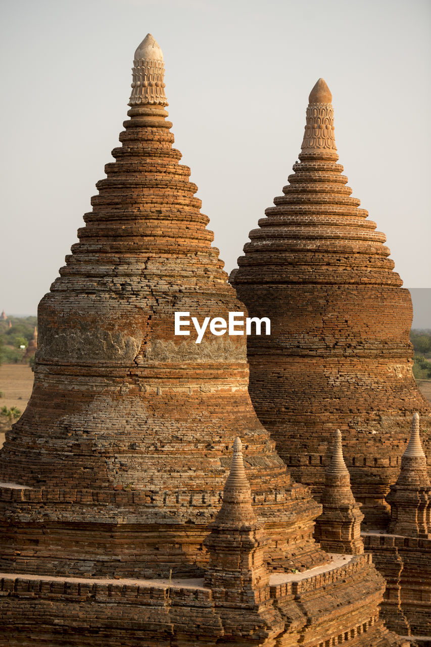 Close-up of stupas against clear sky