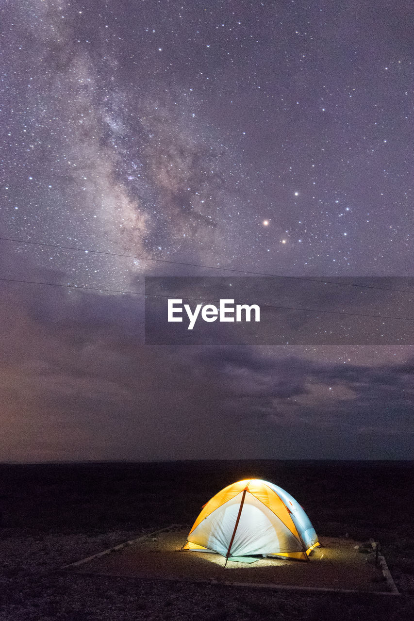 Illuminated tent against sky at night