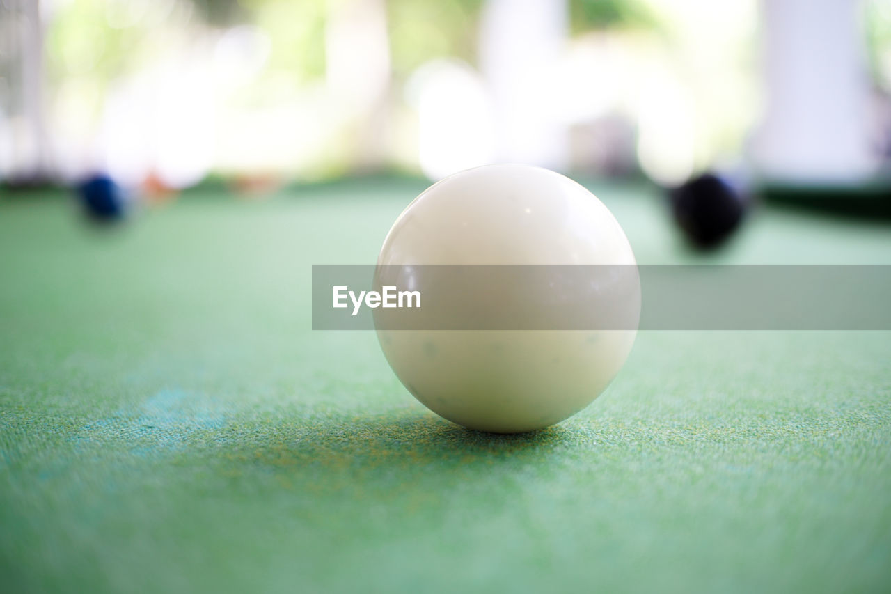 CLOSE-UP OF BALL ON TABLE AT NIGHT