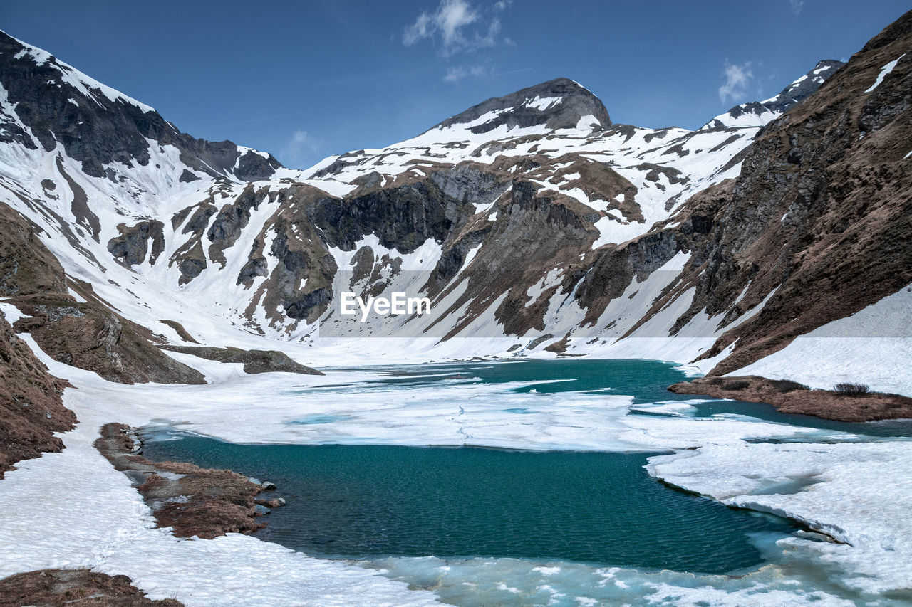 scenic view of snowcapped mountains against sky during winter