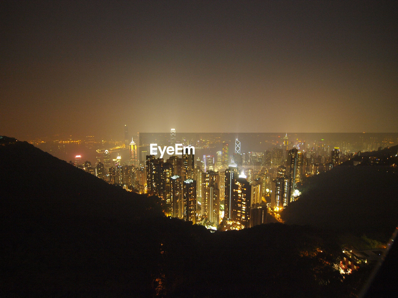 High angle view of illuminated cityscape seen from mountain at night