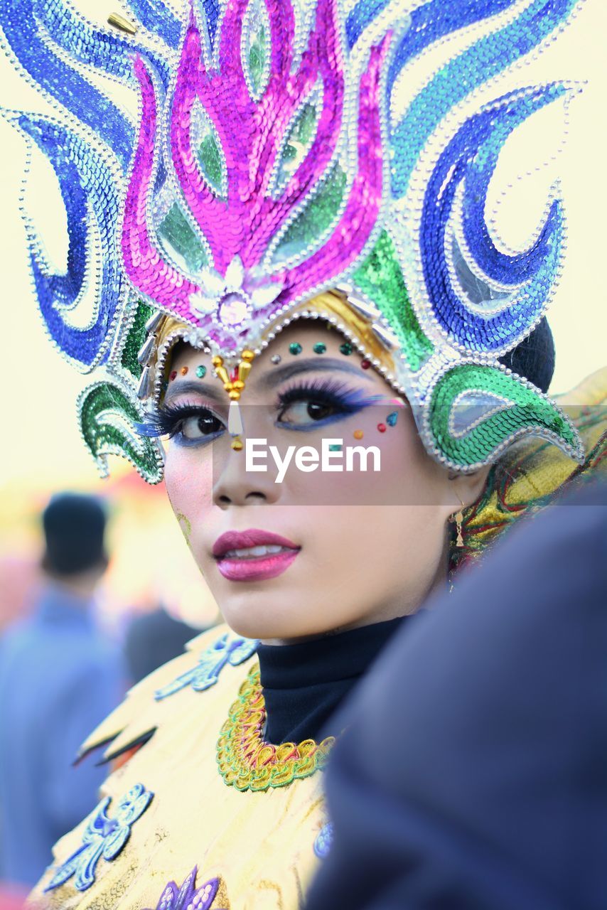 Portrait of beautiful woman wearing venetian make-up at carnival